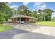 Charming single-story home with a brick exterior, accessible ramp, and mature trees at 9751 N Highway 96, Selma, NC 27576