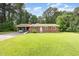 Charming brick ranch home with a lush green lawn and a covered carport for convenient parking at 9751 N Highway 96, Selma, NC 27576