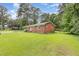 Traditional brick home featuring a well-maintained lawn and mature trees providing ample shade at 9751 N Highway 96, Selma, NC 27576