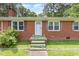 Close-up of the brick home's front door, showcasing the brick facade and small front steps at 9751 N Highway 96, Selma, NC 27576