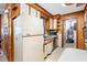 This kitchen features wood paneling, white cabinets, and standard appliances at 9751 N Highway 96, Selma, NC 27576