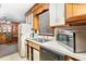 A well-lit kitchen featuring wood trim, white cabinets, and modern appliances at 9751 N Highway 96, Selma, NC 27576