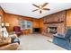 Inviting living room featuring a brick fireplace, plush seating, and a large window with floral curtains at 9751 N Highway 96, Selma, NC 27576