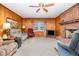 Cozy living room with wood paneling, a brick fireplace, and comfortable seating arrangement at 9751 N Highway 96, Selma, NC 27576