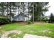 Spacious backyard with mature trees and partial fence at 10 London Way, Spring Lake, NC 28390