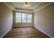 Bright bedroom with hardwood floors, tray ceiling, and natural light at 10 London Way, Spring Lake, NC 28390