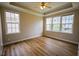 Spacious bedroom with hardwood floors, tray ceiling, and large windows at 10 London Way, Spring Lake, NC 28390