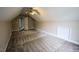 Large carpeted bonus room with sloped ceilings and natural light at 10 London Way, Spring Lake, NC 28390