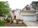 Charming two-story home features a well-manicured lawn, attached two-car garage, and inviting red front door at 10 London Way, Spring Lake, NC 28390
