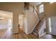 Grand foyer with hardwood floors, staircase, and ample natural light. Open floor plan leads to multiple rooms at 10 London Way, Spring Lake, NC 28390