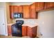 The kitchen has wood cabinets, an electric oven, and a microwave at 10 London Way, Spring Lake, NC 28390