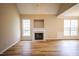 Spacious living room featuring vaulted ceilings, a fireplace, and large windows for ample natural light at 10 London Way, Spring Lake, NC 28390