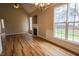 Living room featuring wood floors, fireplace, and large windows offering view of the backyard, bright and airy at 10 London Way, Spring Lake, NC 28390
