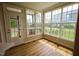 Bright sunroom with multiple windows providing backyard views and access to screened-in porch, perfect for relaxing at 10 London Way, Spring Lake, NC 28390