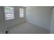 Bright bedroom with new carpet, light walls, and two windows creating a cozy and inviting space at 1000 Regalia Rd # 1, Durham, NC 27713