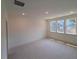 A carpeted bedroom with three windows providing ample natural light, a serene and comfortable space at 1000 Regalia Rd # 1, Durham, NC 27713