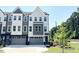 Modern townhome featuring a stylish gray and white exterior with ample windows and two-car garage at 1000 Regalia Rd # 1, Durham, NC 27713