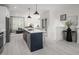Bright, open-concept kitchen with stainless steel appliances and a large island, flowing into the living area at 1000 Regalia Rd # 1, Durham, NC 27713
