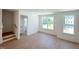 Inviting living room with hardwood floors and large windows offering ample natural light at 1000 Regalia Rd # 1, Durham, NC 27713