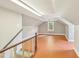 Finished attic area featuring hardwood floors, natural light, and access to the stairwell at 102 W Weatherspoon St, Sanford, NC 27330