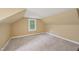 Finished attic bedroom features carpeted floors, a window with natural light, and neutral paint at 102 W Weatherspoon St, Sanford, NC 27330
