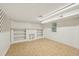 Finished basement space featuring tile floors, built-in shelving, and a small window for natural light at 102 W Weatherspoon St, Sanford, NC 27330