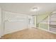 Finished basement area with tiled floors, green accent walls, built-in shelving, and natural light at 102 W Weatherspoon St, Sanford, NC 27330