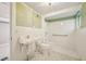Basement bathroom featuring a shower, sink, and toilet, offering functionality and convenience for guests at 102 W Weatherspoon St, Sanford, NC 27330