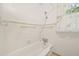 This bathroom features tiled walls, a classic bathtub, and a window for natural light at 102 W Weatherspoon St, Sanford, NC 27330