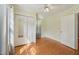 Bright bedroom features hardwood floors, a ceiling fan, and a closet with mirrored doors at 102 W Weatherspoon St, Sanford, NC 27330