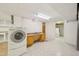 Laundry room in the basement featuring white appliances, a sink, and tile flooring for added convenience at 102 W Weatherspoon St, Sanford, NC 27330