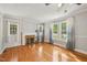 Bright living room with hardwood floors, fireplace, and large windows dressed with ombre curtains at 102 W Weatherspoon St, Sanford, NC 27330