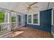 Comfortable screened-in porch features tile flooring and views of home's exterior at 102 W Weatherspoon St, Sanford, NC 27330