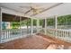Enclosed back porch featuring tile flooring and a ceiling fan for outdoor comfort at 102 W Weatherspoon St, Sanford, NC 27330