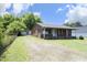 Inviting brick home featuring a detached garage and a charming covered front porch at 107 Rencher St, Hillsborough, NC 27278