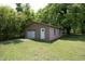 Detached garage with a white roll-up door and a white entry door at 107 Rencher St, Hillsborough, NC 27278