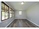 Comfortable room showcasing laminate floors, neutral paint, and multiple bright windows at 107 Rencher St, Hillsborough, NC 27278