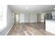 An open-concept living room and kitchen boast wood-look floors and natural light at 107 Rencher St, Hillsborough, NC 27278