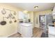 Bright, functional kitchen with white cabinets, stainless steel appliances, and laminate wood flooring at 110 Oak Park Dr, Benson, NC 27504