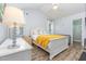 Serene main bedroom with vaulted ceilings, a ceiling fan, white furniture, and an attached bath at 110 Oak Park Dr, Benson, NC 27504