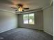 The primary bedroom features a tray ceiling, a fan, carpet, and a great view at 111 Bonsai Way, Four Oaks, NC 27524