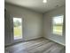 The dining room area features lovely wood flooring, a bright window, and access to the backyard at 111 Bonsai Way, Four Oaks, NC 27524