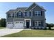 Beautiful two-story home with a well-manicured lawn and a two-car garage at 111 Bonsai Way, Four Oaks, NC 27524
