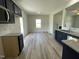The second view of the kitchen offers an open concept to the dining area and fireplace at 111 Bonsai Way, Four Oaks, NC 27524