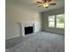 Spacious living room featuring a cozy fireplace and lots of natural light at 111 Bonsai Way, Four Oaks, NC 27524