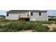 Exterior of a two-story home featuring a wooden deck and a spacious grassy backyard at 111 Coharie Dr, Lillington, NC 27546