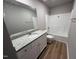 Clean bathroom featuring a shower-tub, granite countertop vanity, and modern white cabinets at 111 Coharie Dr, Lillington, NC 27546