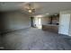 Open-concept living space with carpeted living room and open access to the kitchen at 111 Coharie Dr, Lillington, NC 27546