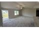 Bright living room featuring plush carpeting, vaulted ceilings, and ample natural light at 111 Coharie Dr, Lillington, NC 27546