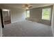 Cozy main bedroom with plush carpeting, natural light, and en-suite bathroom access at 111 Coharie Dr, Lillington, NC 27546
